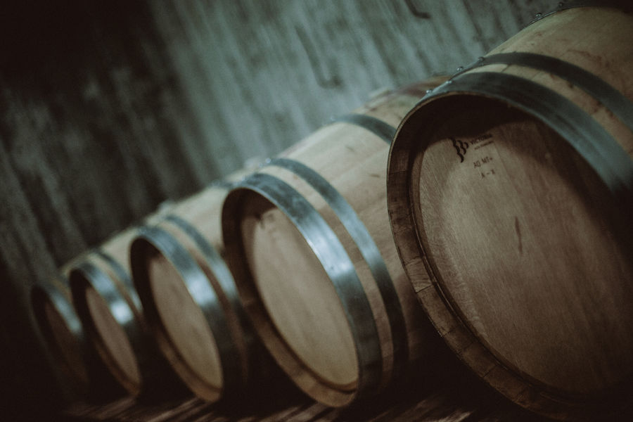 lying wine wooden barrels in a row at Pantou winery